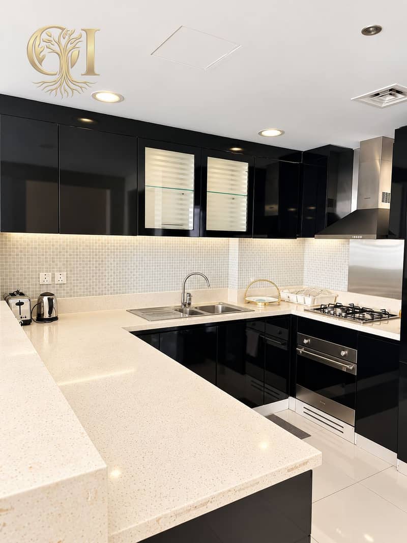 6 Sleek Black and Quartz Modern Kitchen. png