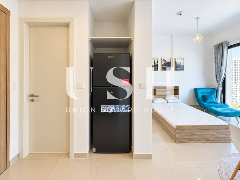 5 Bright Minimalist Studio with Centered Refrigerator. png