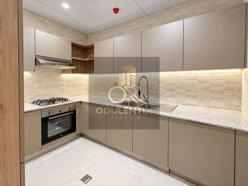 2 Modern Taupe Kitchen with Warm Lighting. png
