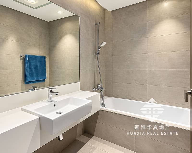 7 Modern Gray-Beige Bathroom with Blue Towel. png