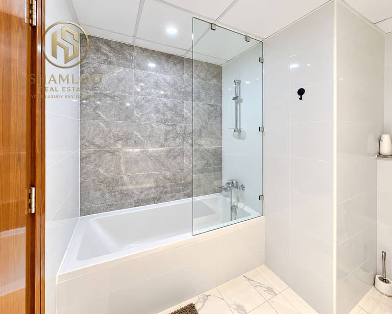 11 Modern Marble-Tiled Bathroom Alcove. png