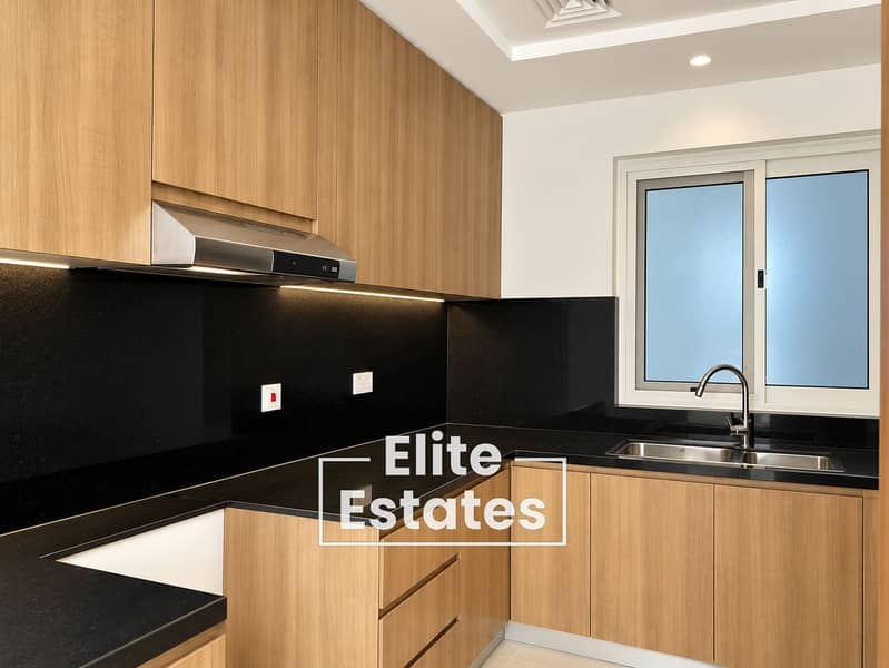 8 Modern Oak and Black L-Shaped Kitchen. png