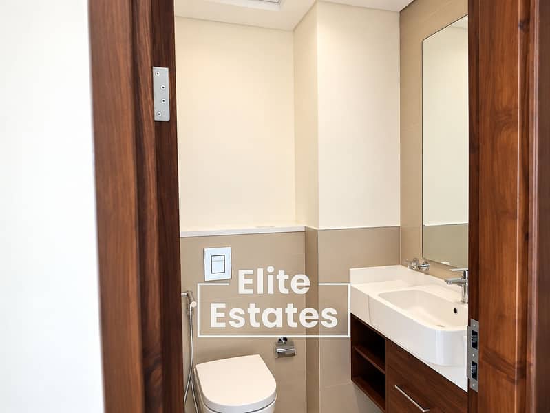 11 Modern Walnut-Trimmed Minimalist Bathroom. png