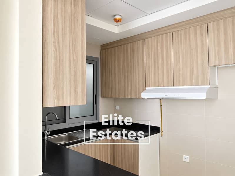 10 Minimalist Oak Kitchen with Black Countertops. png