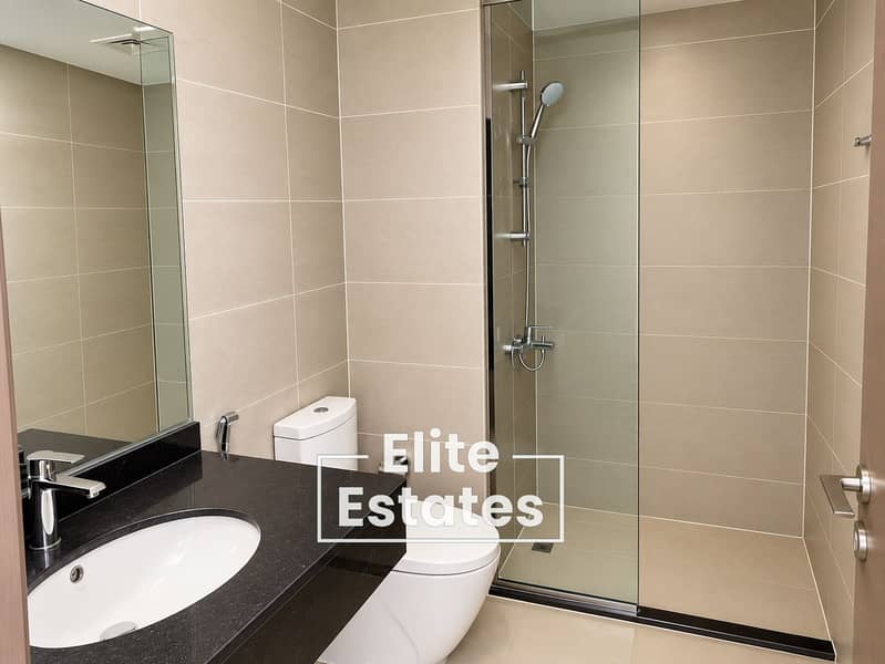 13 Minimalist Beige-Tiled Bathroom. png