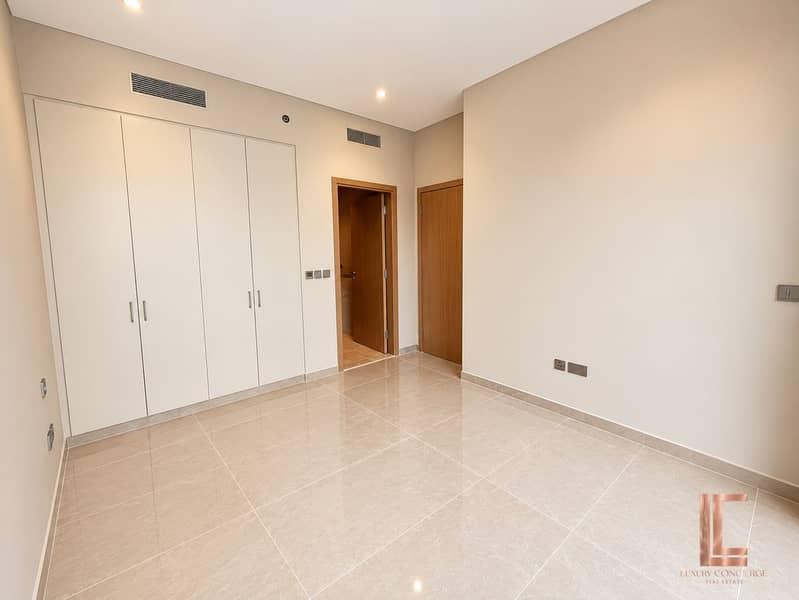 4 Minimalist Beige Room with Built-In Wardrobes. png