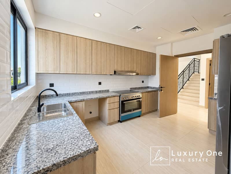 4 Bright Minimalist Kitchen with Open Stairway. png