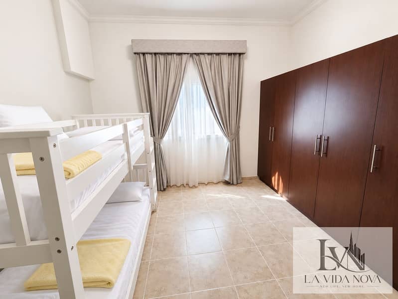 4 Bright white bunk bedroom with yellow blankets. png