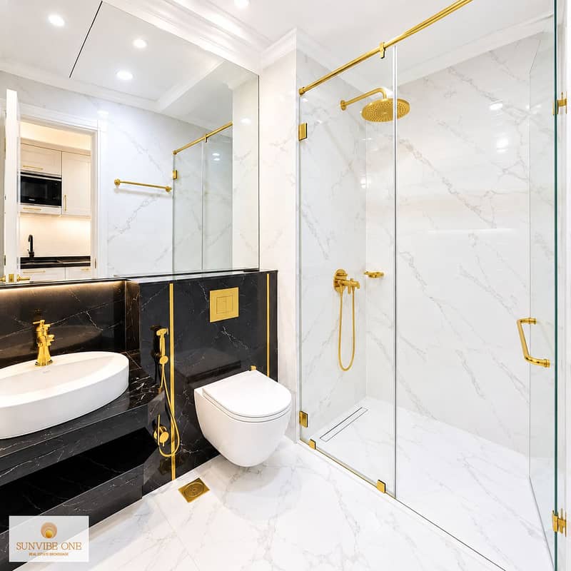 8 Bright Unfurnished Marble Bathroom with Gold Fixtures. png