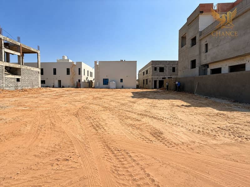 2 Modern Construction Courtyard Under Blue Skies. png