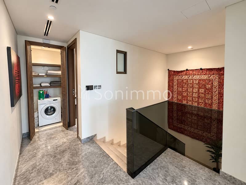 8 Modern Hallway with Laundry Nook and Stairwell. png