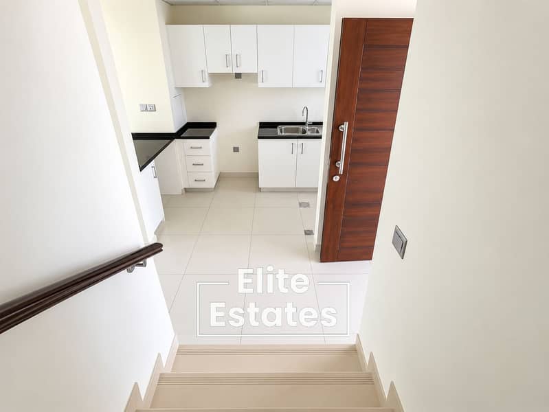 4 Minimalist Kitchen Seen from Staircase. png