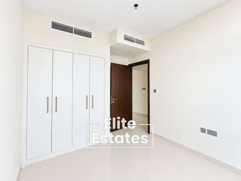 6 Minimalist Bedroom with Wardrobe and Open Door. png
