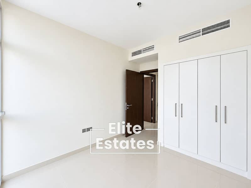 7 Minimalist Cream Bedroom with Dark Wood Door. png