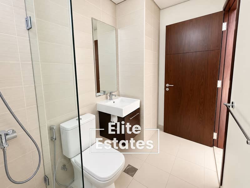 9 Modern Beige-Tiled Bathroom. png