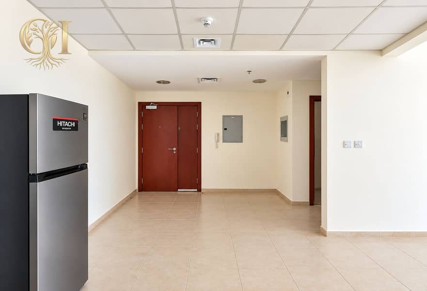 9 Neutral Entryway with Refrigerator and Double Doors. png