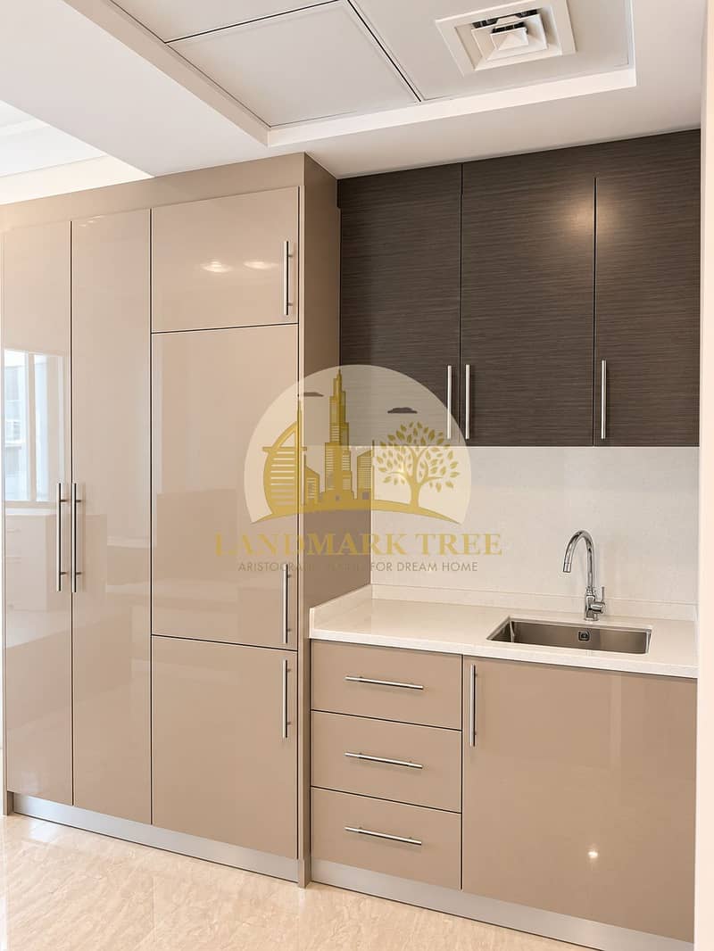 4 Modern Taupe Kitchenette with Stainless Accents. png