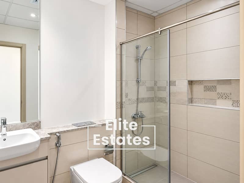9 Modern Beige Bathroom with Glass Shower. png