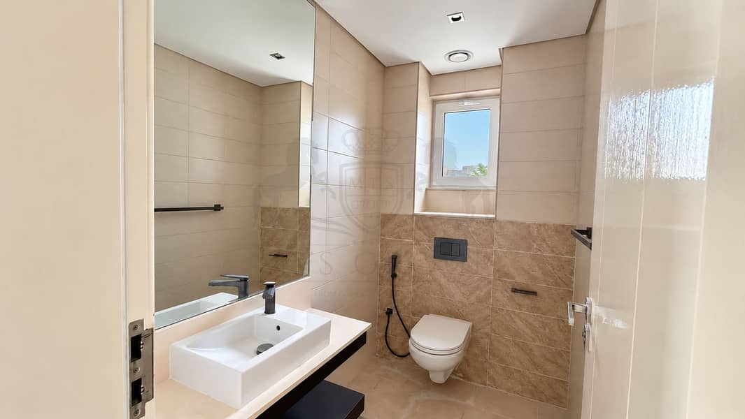 16 Minimalist Beige Bathroom with Closed-Lid Toilet. png