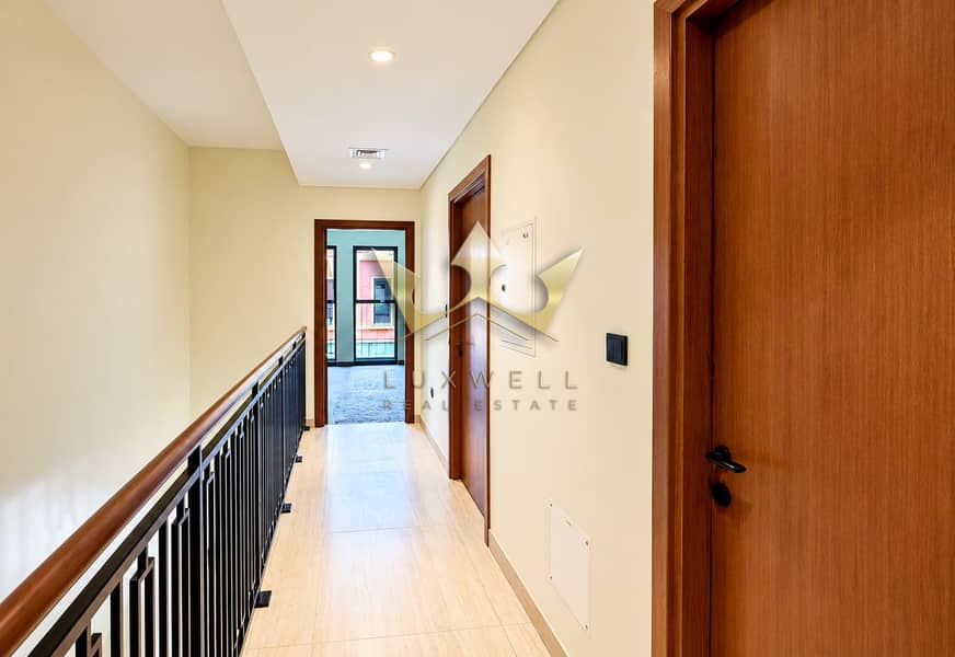 12 Modern Hallway with Wooden Doors and Railing. png