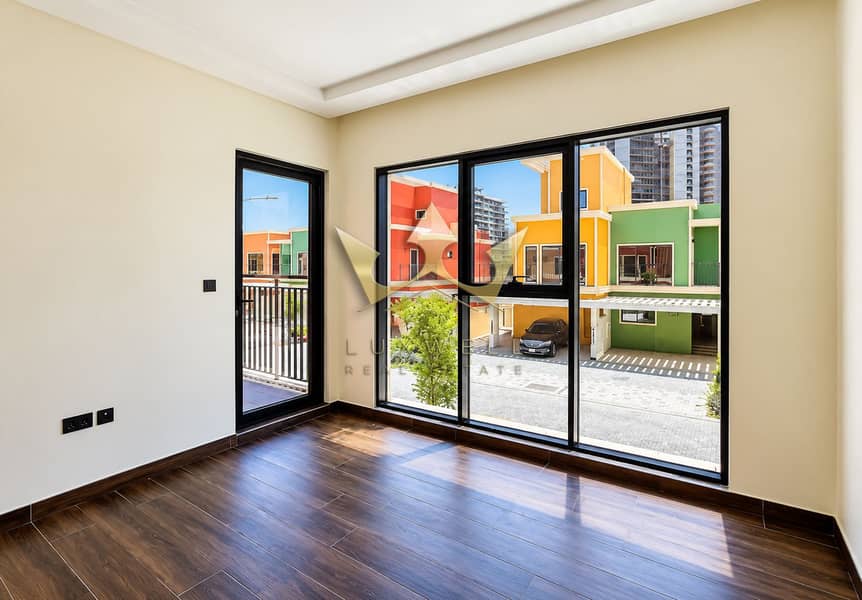 13 Sunlit Empty Room with Colorful Villas. png