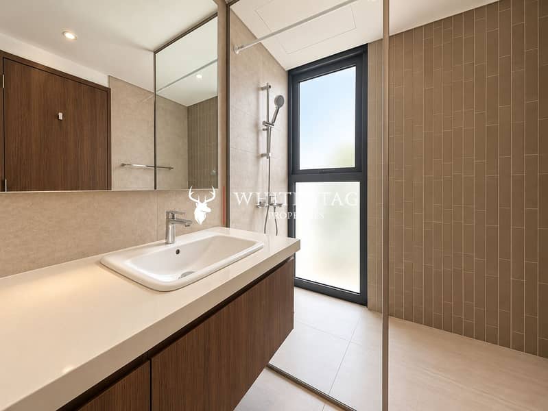 15 Modern Beige Bathroom with Glass Shower. png