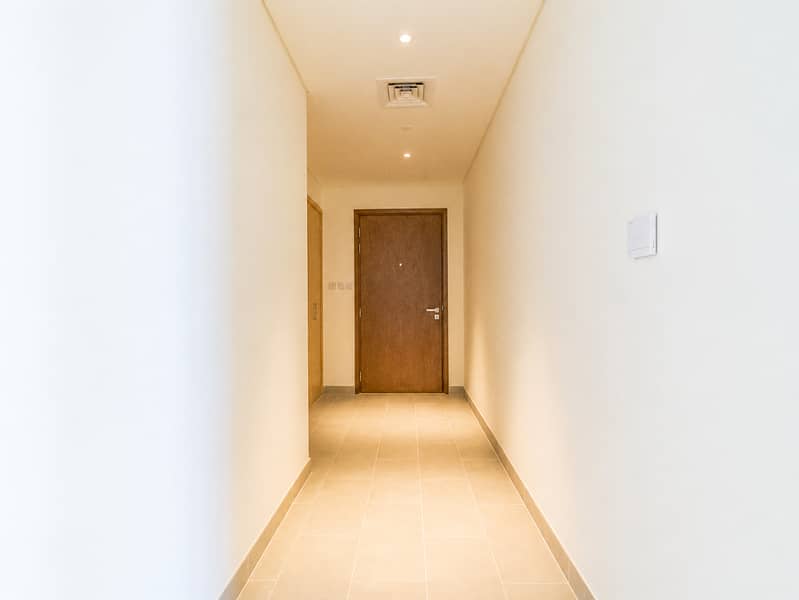 22 Minimalist Hallway to a Wooden Door. png