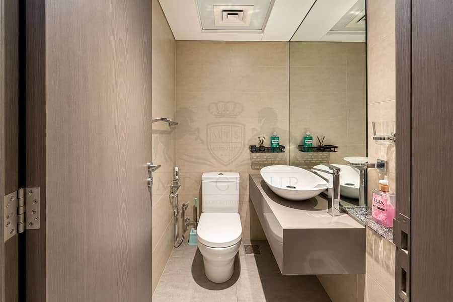 7 Modern Taupe Bathroom with Mirrored Vanity. png