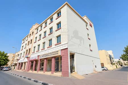 Shop in affitto a International City, Dubai - Sunlit Dar Al Manar Corner Building. png Shop in affitto a International City, Dubai - Sunlit Dar Al Manar Corner Building. png