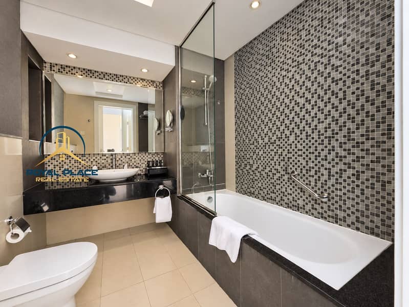 8 Naturally lit mosaic tile bathroom. png