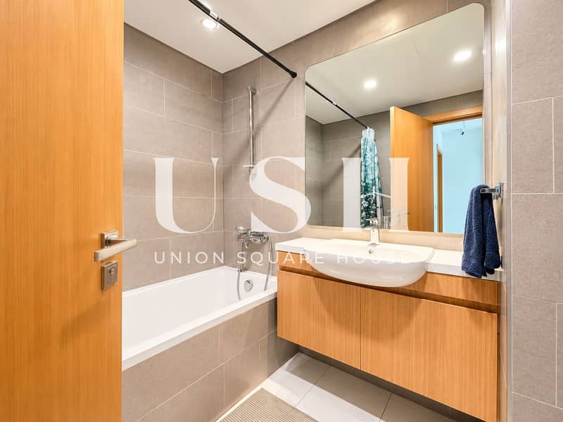 8 Modern Gray-Tile Bathroom with Wood Vanity. png