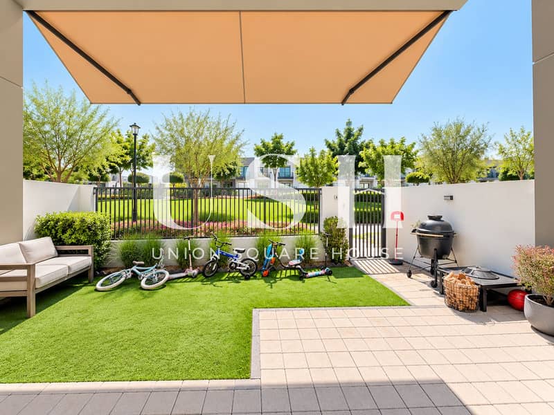 14 Sunny L-Shaped Patio Backyard with Toys. png