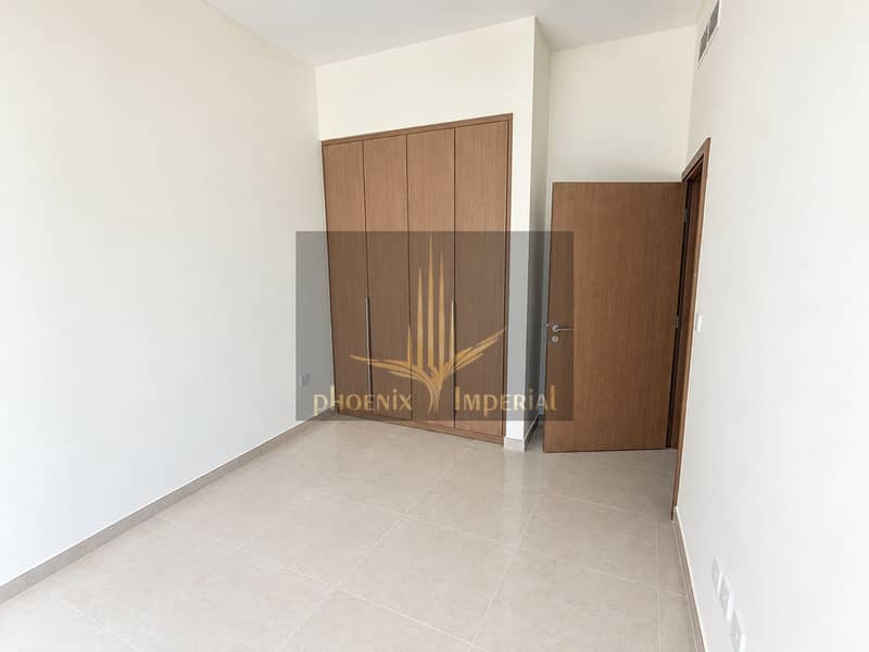 6 Minimalist Room with Wood Wardrobe and Open Door. png