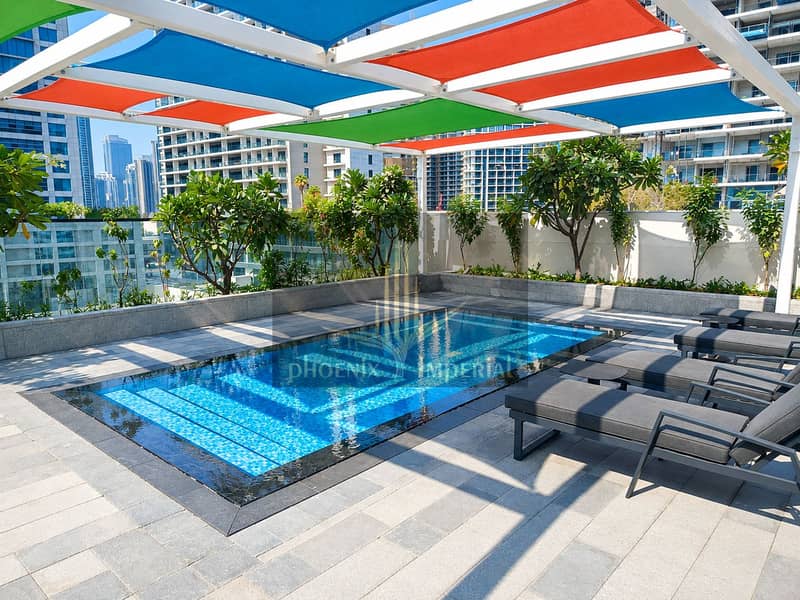 10 Sunlit Rooftop Pool and City Skyline. png