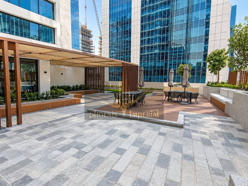 11 Sunlit Modern Courtyard with Rooftop Seating. png