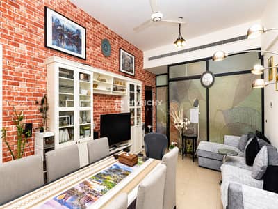 1 Bedroom Flat for Sale in Dubai Silicon Oasis (DSO), Dubai - Cozy Brick-Walled Living and Dining Room. png