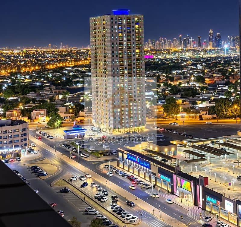 2 Blue-Crowned Tower Over City Lights. png
