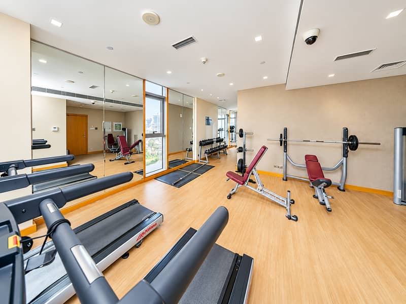 4 Bright Modern Gym with Mirrors and Treadmills. png