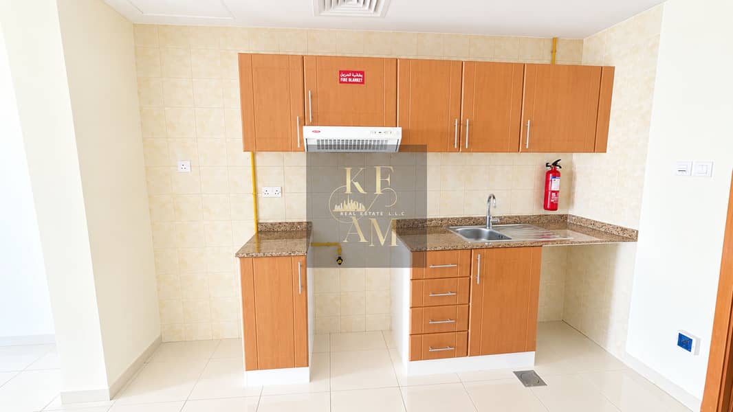 16 Clean Modern Kitchenette with Fire Safety Accents. png