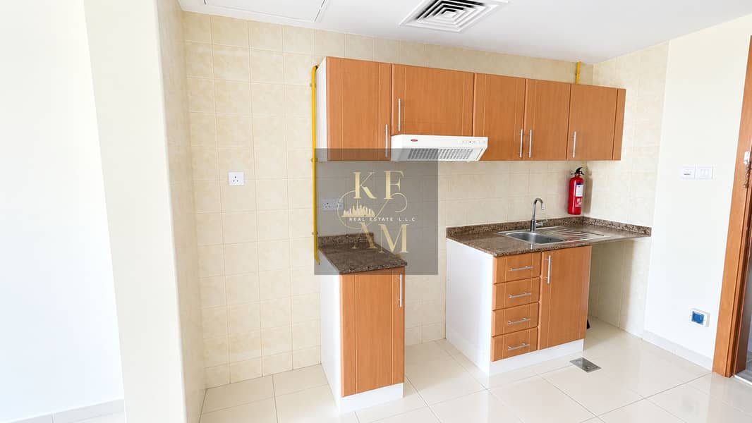 18 Bright Modern Kitchen with Warm Wood Cabinets. png