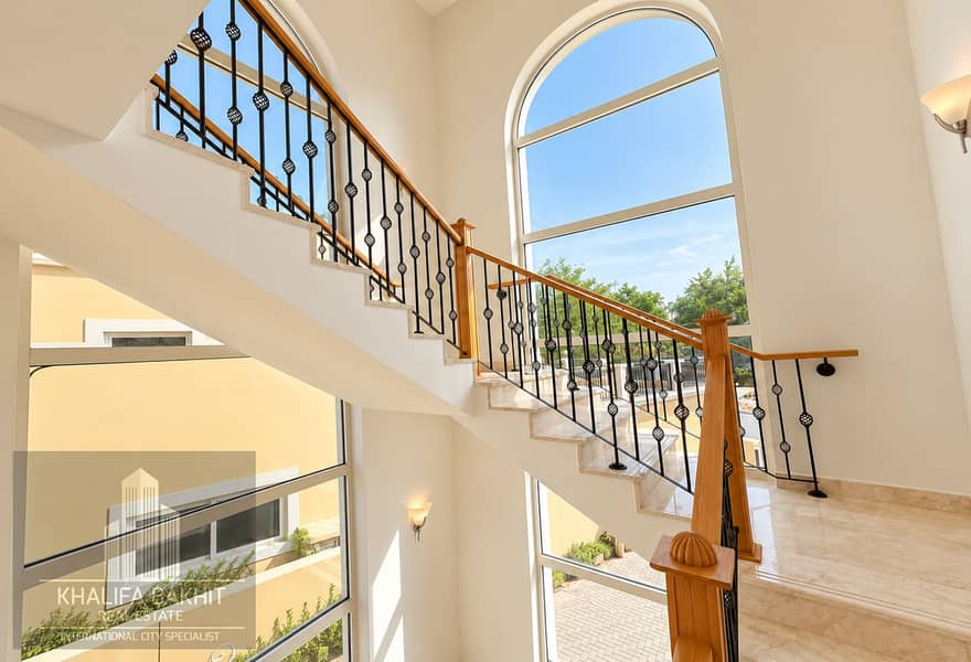 12 Sunlit Marble Staircase with Arched Windows. png