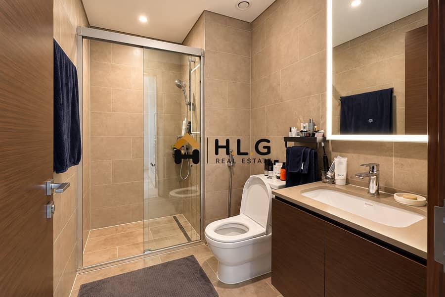 9 Modern Beige Tile Bathroom with Navy Accents. png