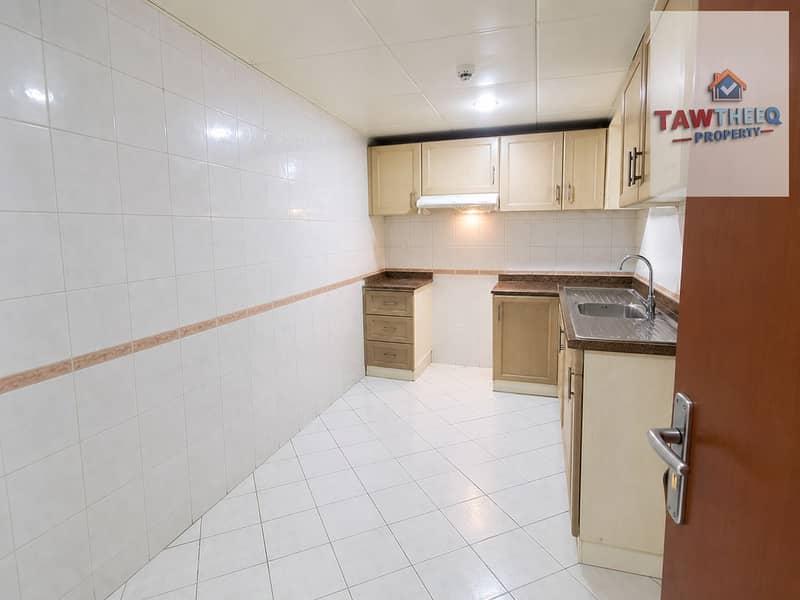 8 Bright Compact Tiled Kitchen. png