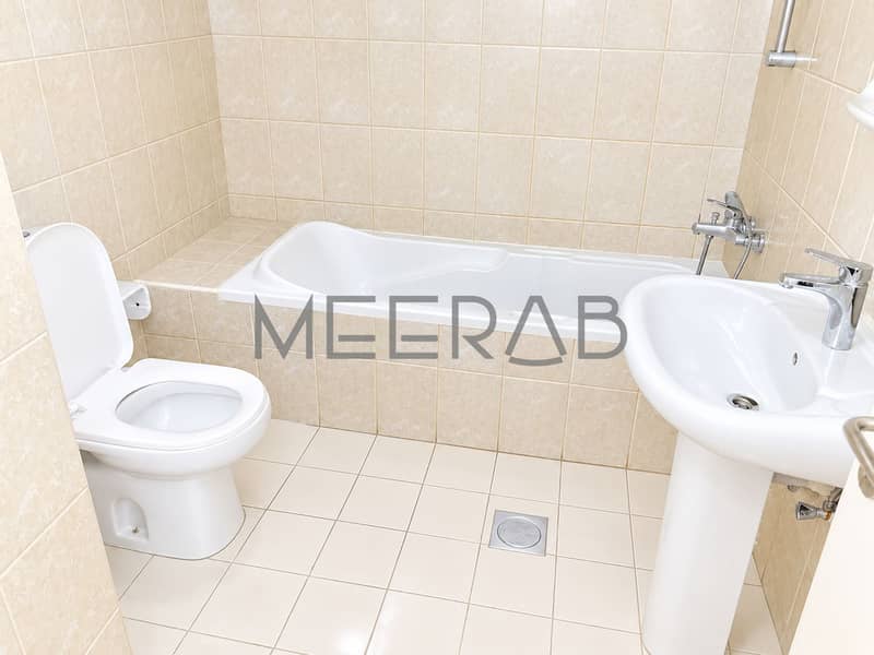 10 Bright Minimalist Beige-Tiled Bathroom. png