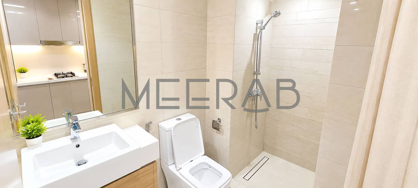6 Modern Beige Bathroom with Reflected Kitchen. png