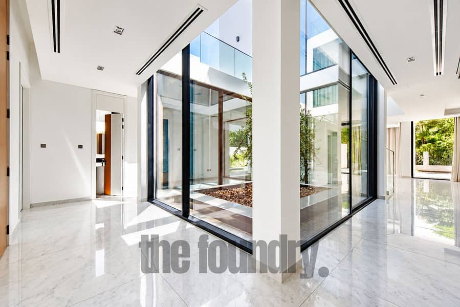 4 Sunlit Minimalist Glass Atrium Corridor. png