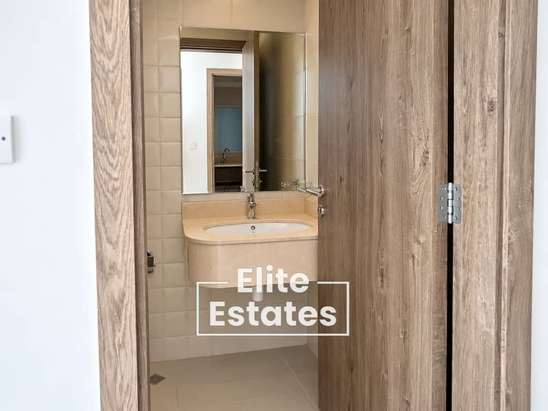 14 Modern Beige Bathroom Through Open Door. png