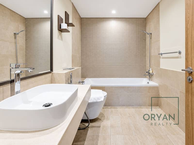 8 Minimalist Beige Bathroom with Chrome Accents. png