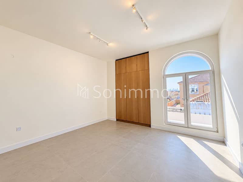 7 Bright Minimalist Room with Arched Window. png
