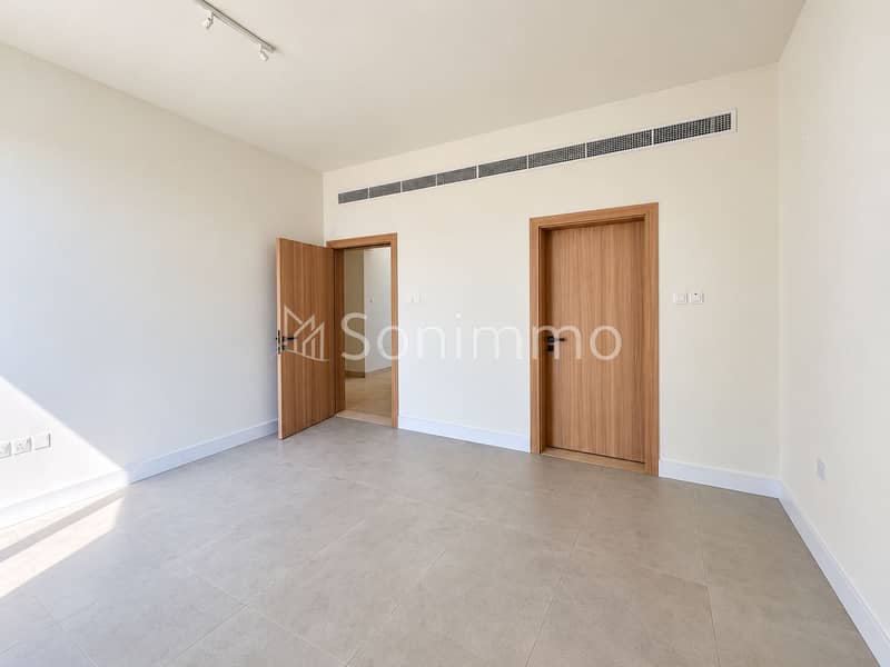 11 Minimalist Sunlit Room with Oak Doors. png